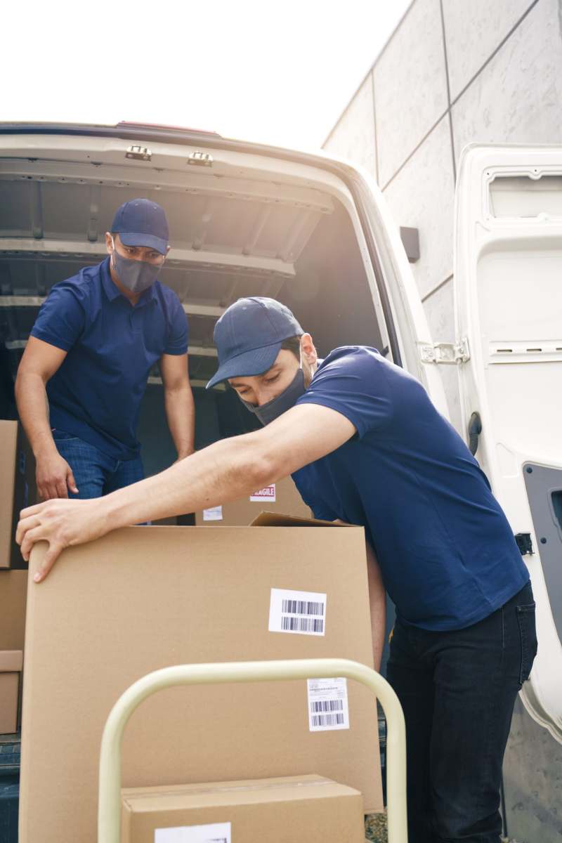 two-couriers-in-protective-masks-unloading-package-2021-09-03-04-15-39-utc (1)